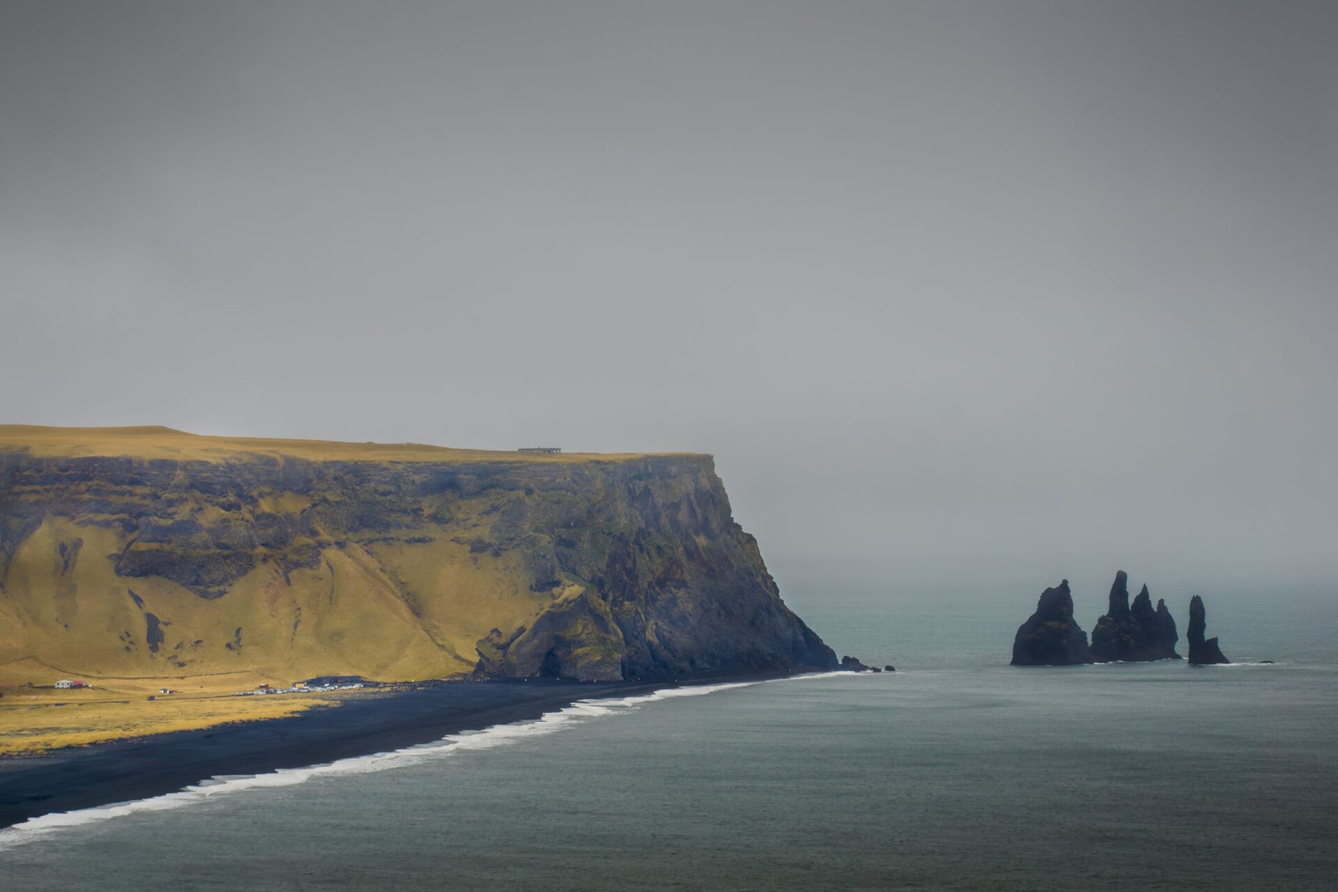 Reynisdrangar sea stacks off Reynisfjara under a grey sky